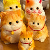 A collection of orange and white cat-shaped squishy stress relief toys sitting together.