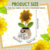 Handmade crochet sunflower pot doll with yellow petals and green leaves displayed in a framed picture.