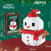 A white and red Christmas snowman built from interlocking plastic blocks, packaged with a festive green background.