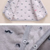 A light gray fleece jacket with a subtle gray mustache print and matching pants.