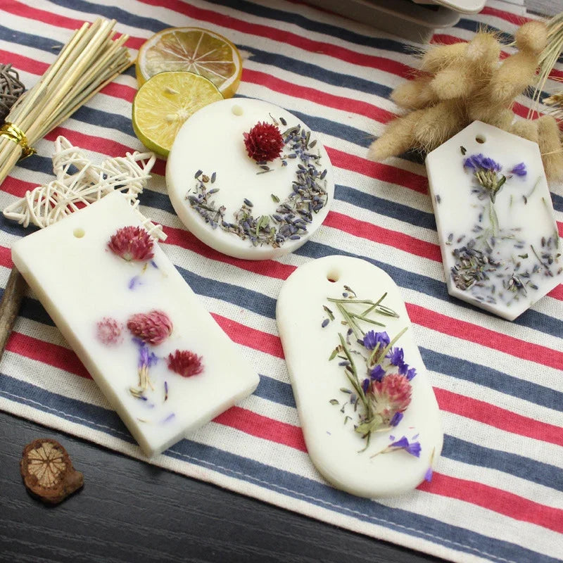 White hexagonal silicone molds for handmade soap and candles decorated with dried flowers and herbs