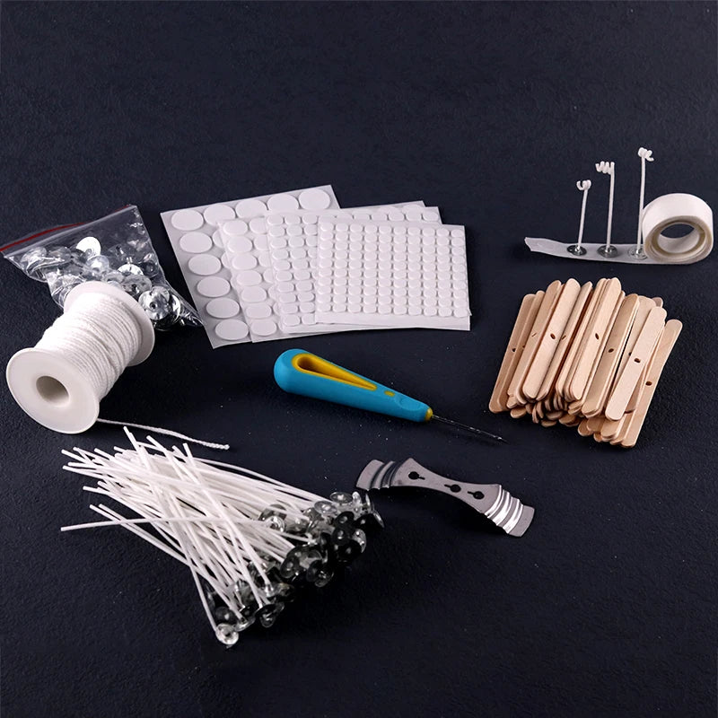 A collection of pre-waxed cotton candle wicks with metal sustainers, including various sizes and a spool.