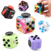 A collection of colorful fidget cubes in various colors and designs, including black, purple, green, and yellow.