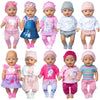 A collection of eight 18-inch doll outfits featuring various pink and white clothing, including shirts and pants.