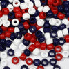 A pile of multicolor pony beads in various colors including red, blue, white, and purple.