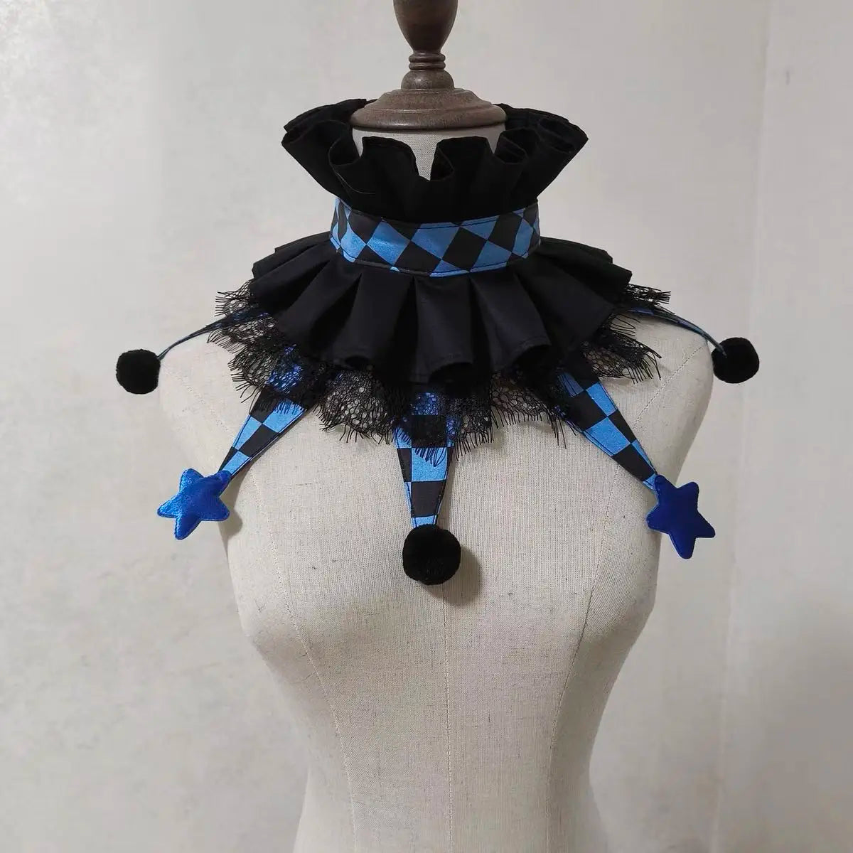 Black and blue checkered ruff collar accessory with black and blue fabric accents displayed on a mannequin.