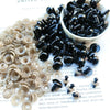 A collection of black and clear plastic safety eyes for crafting, including round and irregular shapes.