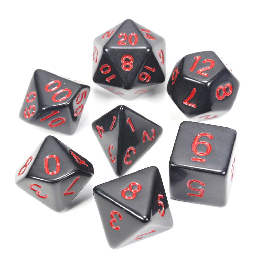 A collection of black acrylic dice showing various numbers and shapes used for tabletop role-playing games