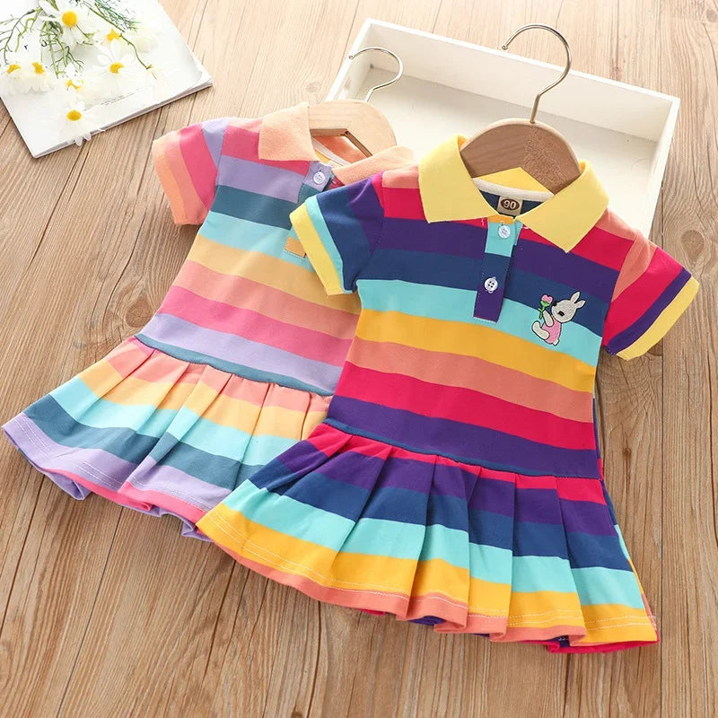 A colorful kids summer dress featuring horizontal rainbow stripes and a rabbit embroidery detail.