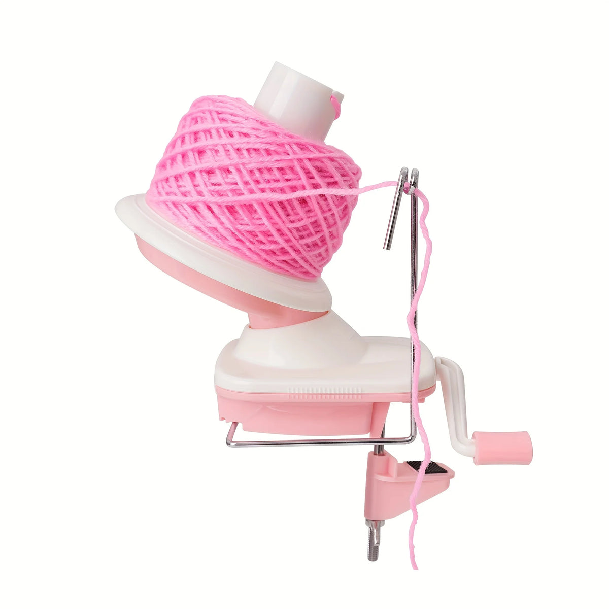 A pink hand crank yarn winder device with a pink ball of yarn and a metal frame.
