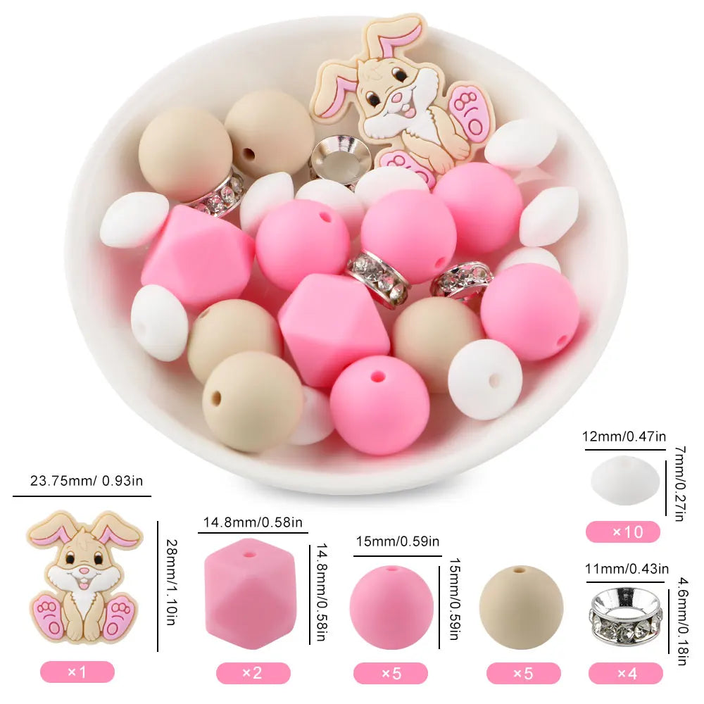 A bowl filled with pink and beige silicone beads shaped like cartoon rabbits for DIY jewelry making