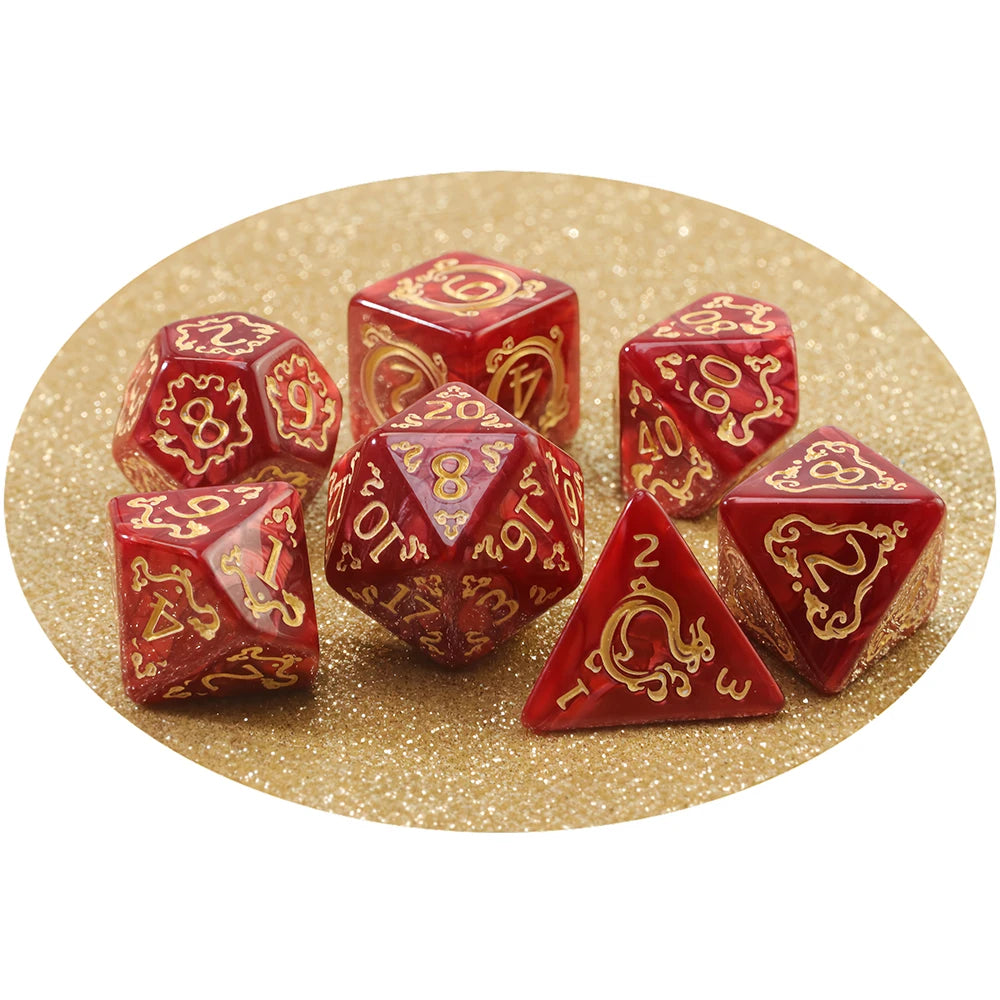 A set of red polyhedral dice, including d20s and dodecahedrons, scattered on a gold glitter background.