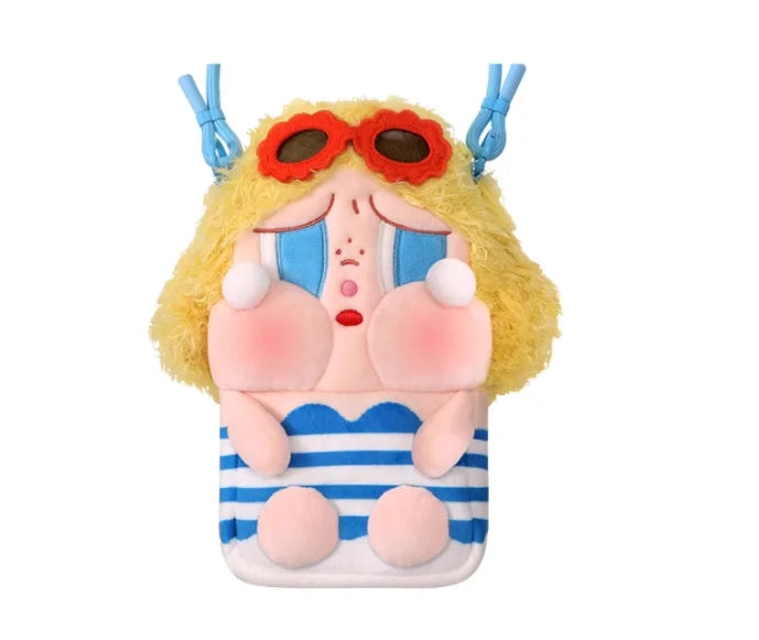 A plush vinyl figure of a crying character with yellow hair and orange goggles wearing striped clothing.