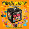 A box of mystery squish toys with various colorful squishies and accessories scattered around.