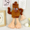 A brown, plush shark toy with large eyes and fins is displayed on a white surface.