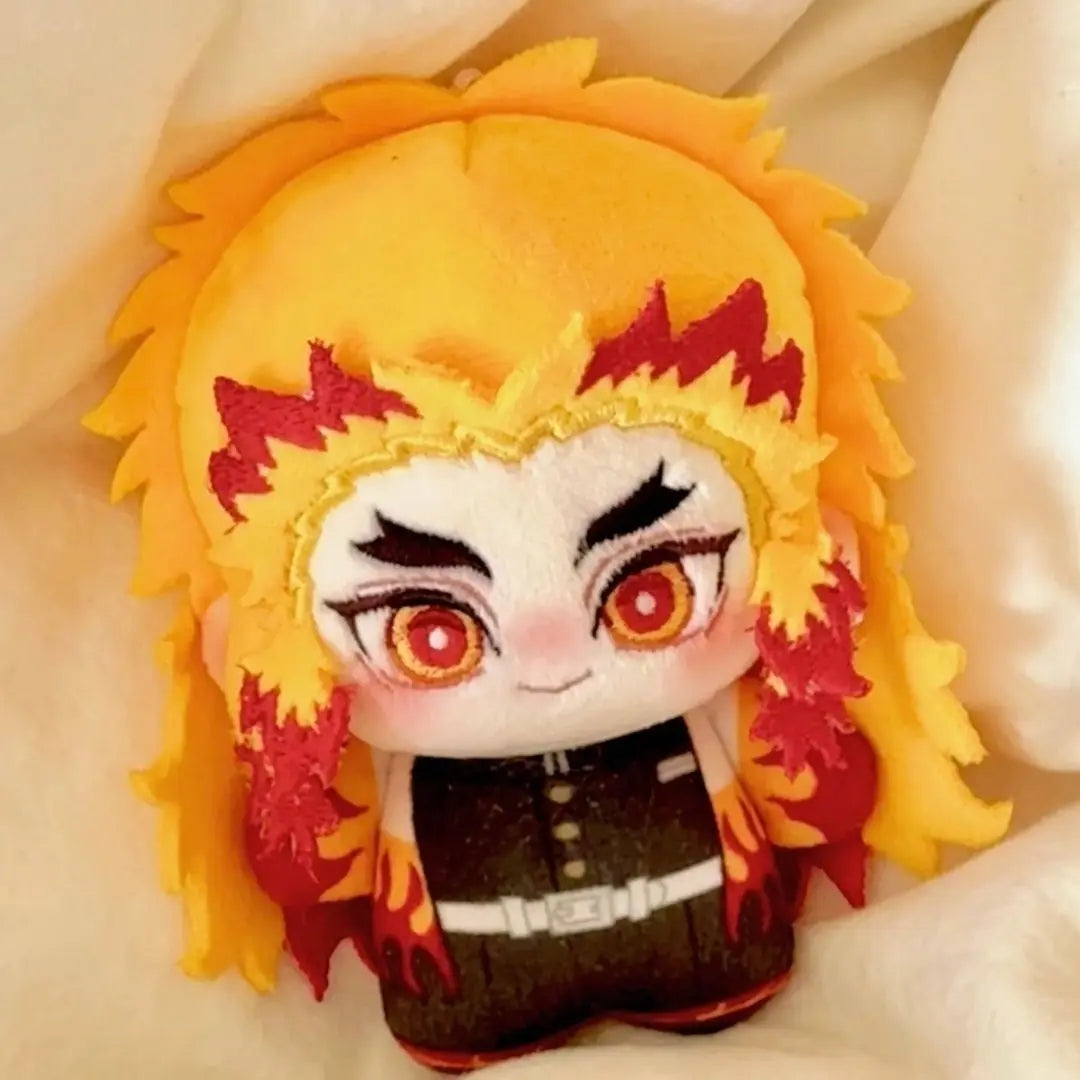 A cute anime plush doll of a character with bright yellow hair and red accents.