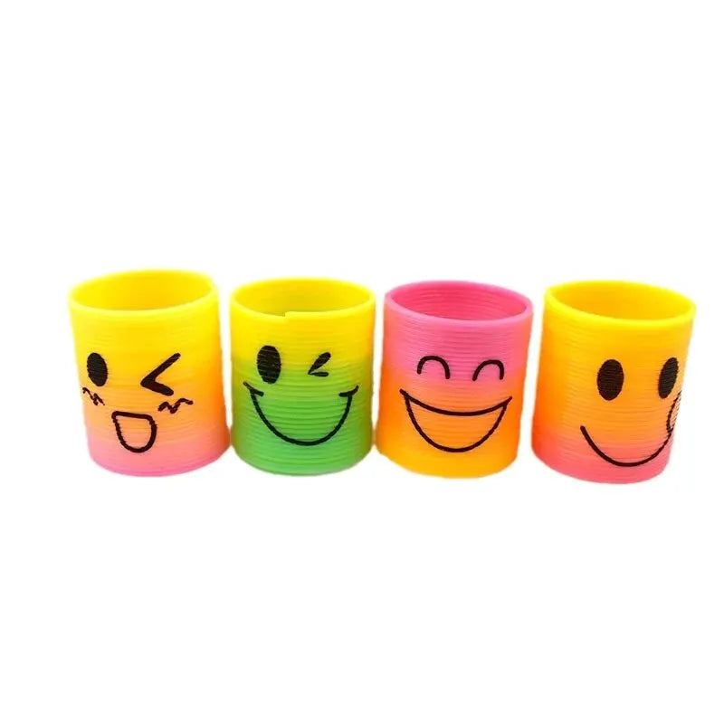 A set of four colorful stacking circles or play mats in yellow, green, pink, and orange.