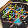 A black game board with triangular pieces and a rubber band forming a small triangle.