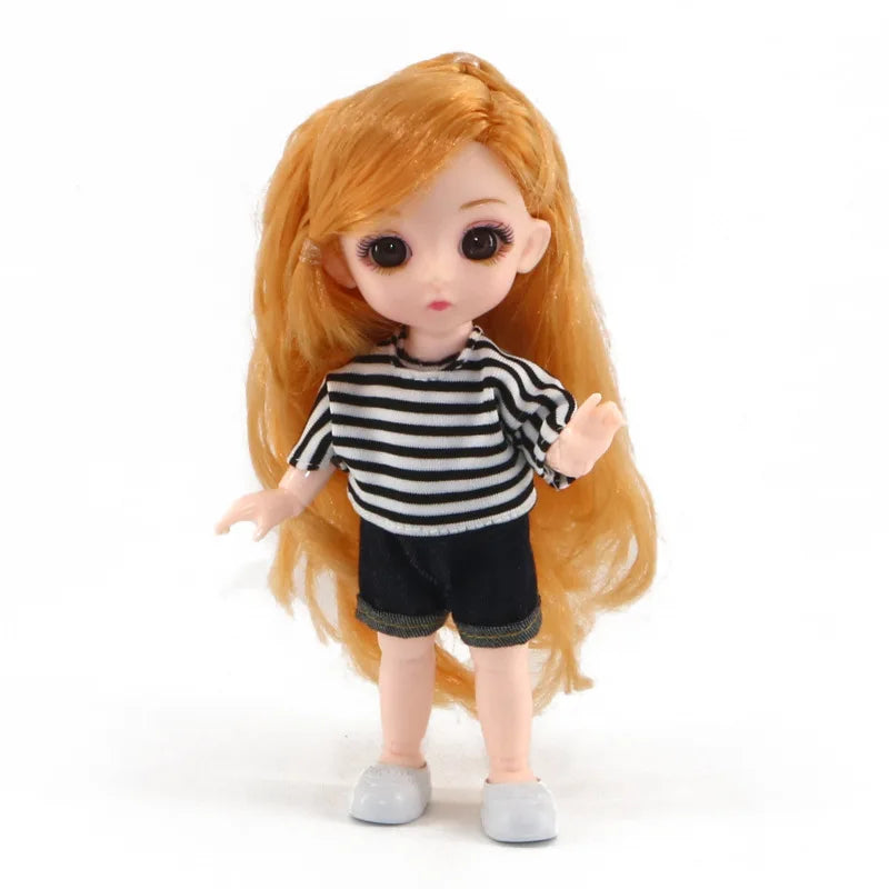An orange-haired Articulated BJD princess doll wearing a black and white striped top and dark shorts.