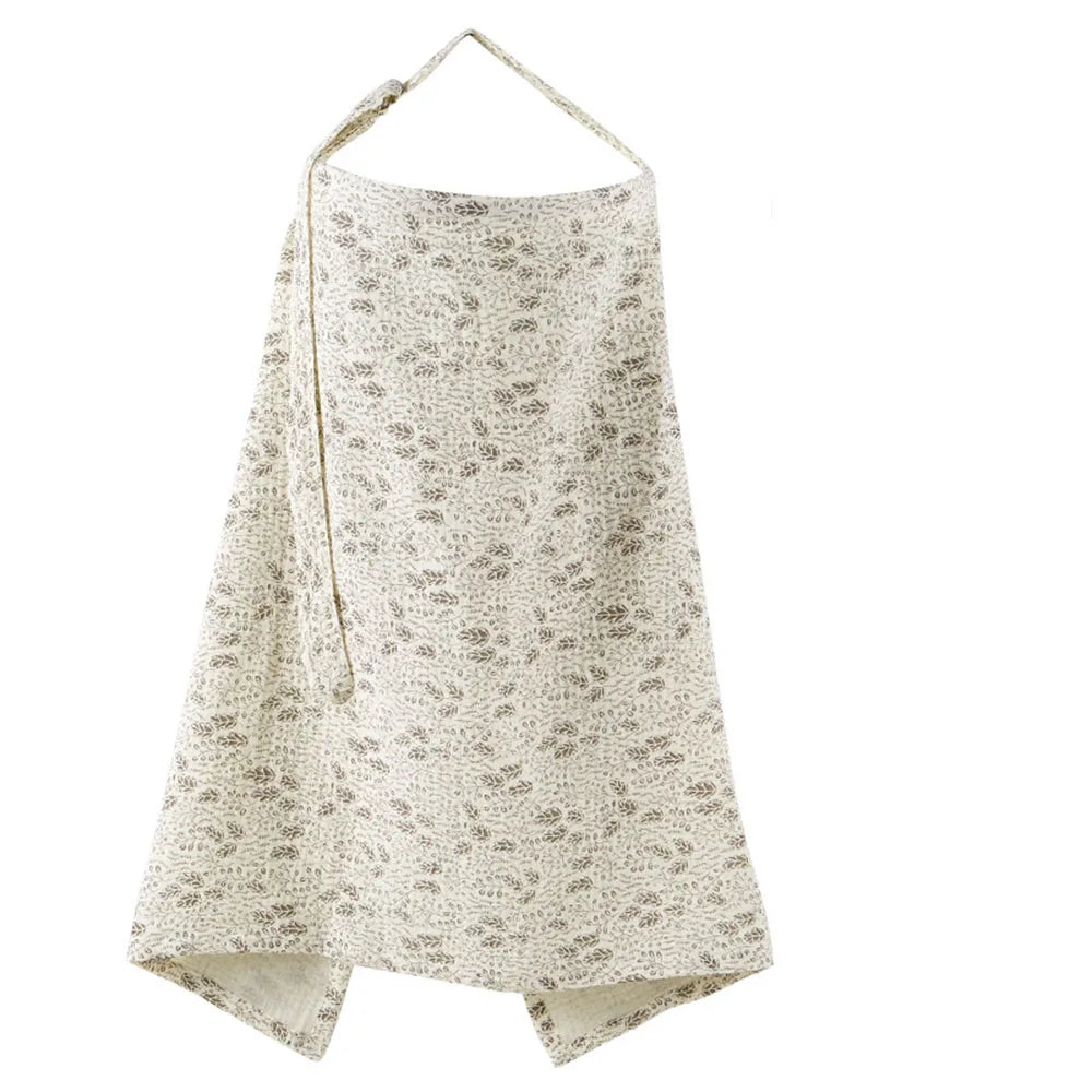 A beige breathable muslin nursing cover with a floral print and adjustable neckline.