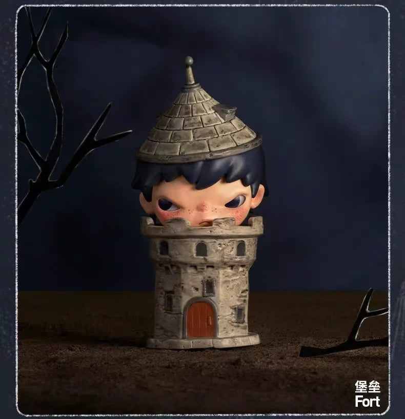 A collectible figurine of a small, frowning character dressed in dark blue and gray, standing in a stone tower setting.