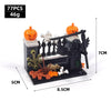 A set of black building blocks depicting a haunted house scene with an orange pumpkin and spooky accessories.