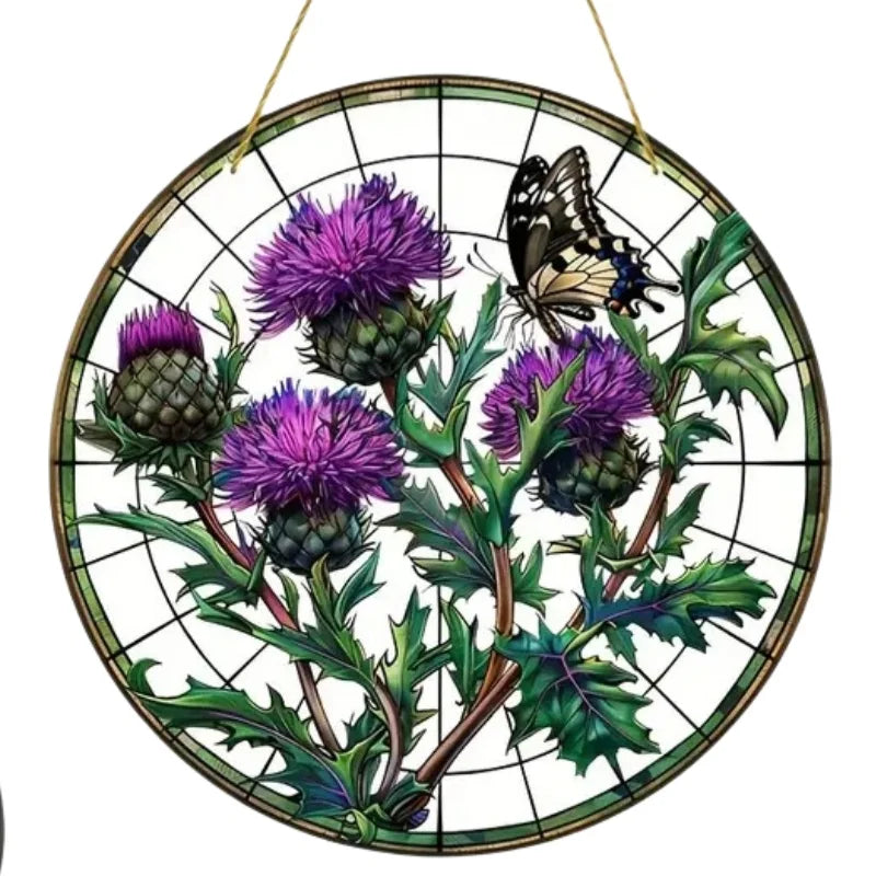 A round acrylic window hanging featuring purple Scottish thistles and a black butterfly against a dark green background.