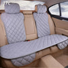 A gray quilted car seat protector with a matching seat cover is shown inside a vehicle.