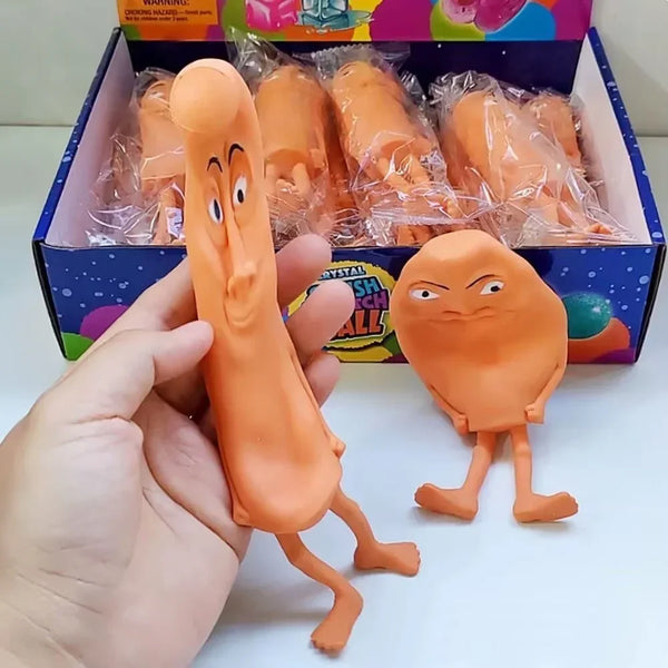 An orange sensory decompression toy shaped like a cartoon character is held in a hand next to its packaging.
