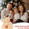 A family of three smiling in a cozy setting with a wooden elk puzzle decoration.