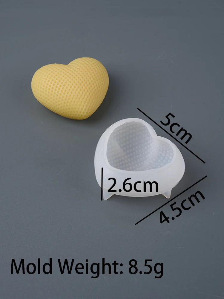 A yellow heart-shaped silicone mold and a clear heart-shaped mold are shown against a gray background.