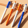 Four colorful squirt water spray ballpoint pens in white, blue, and orange are displayed on a light background.
