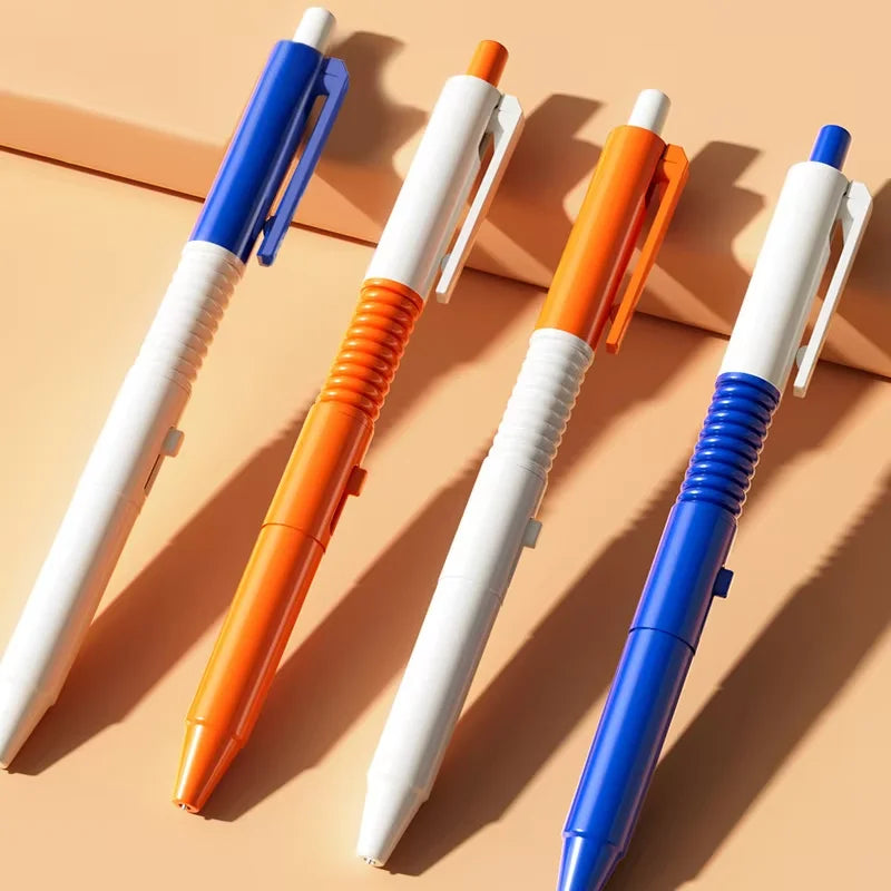 Four colorful squirt water spray ballpoint pens in white, blue, and orange are displayed on a light background.