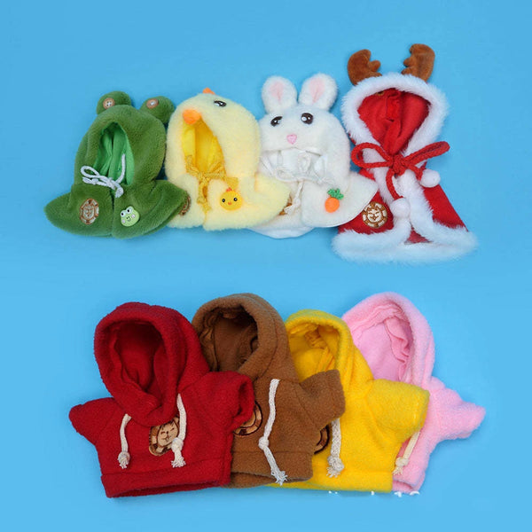 A collection of adorable pet clothing accessories including a green hood, a yellow fluffy item, and a white bunny-themed garm