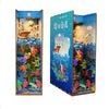 A wooden DIY book nook kit featuring a detailed miniature landscape with aquatic and aerial scenes illuminated by LED lightin