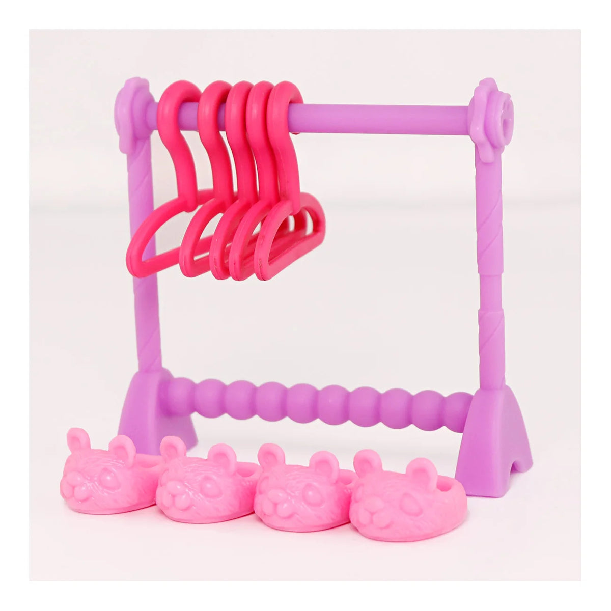 A pink doll laundry accessory set featuring a drying rack and pink plastic hangers and small pink cups.