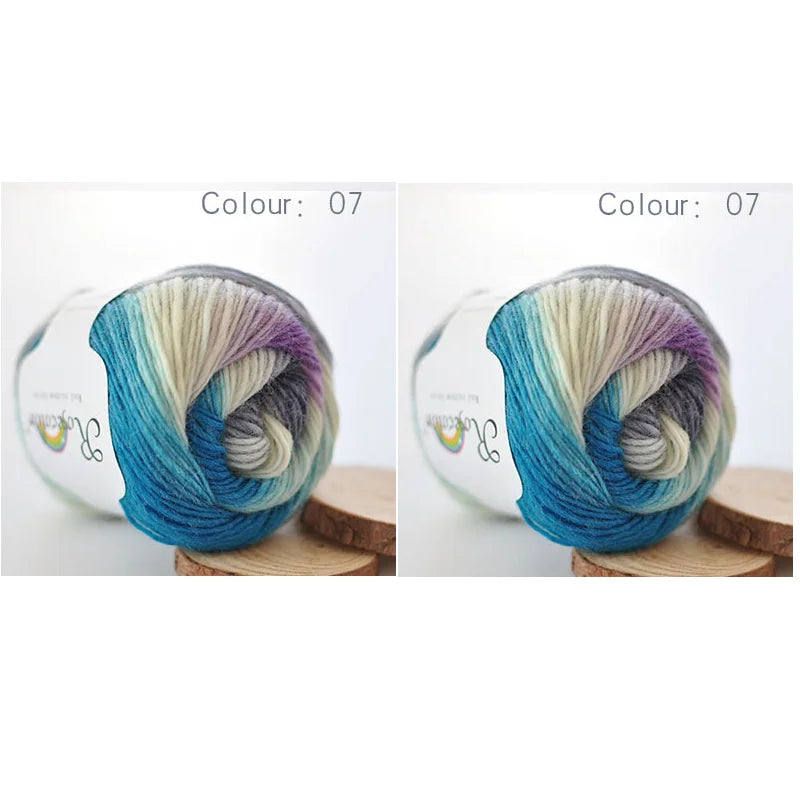 A ball of hand-dyed rainbow merino wool yarn in shades of blue, green, and purple, shown from the side.