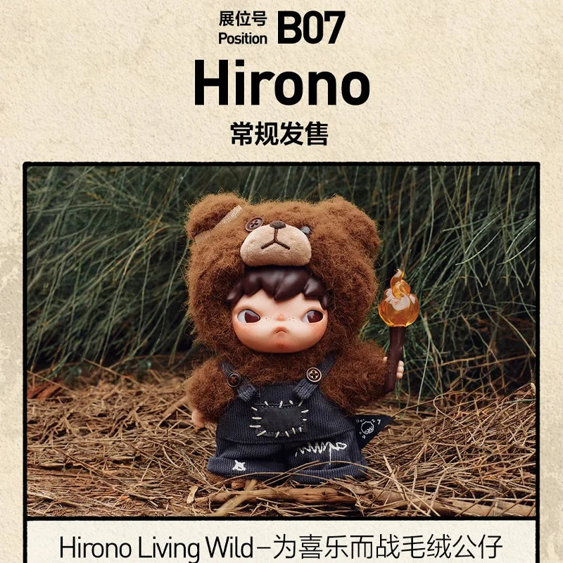 A collectible figure of a brown bear wearing a black outfit and holding a small glowing object, set in a natural, earthy envi