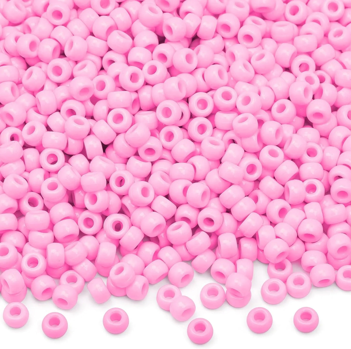 A pile of small pink pony beads for jewelry, braids, and crafts.