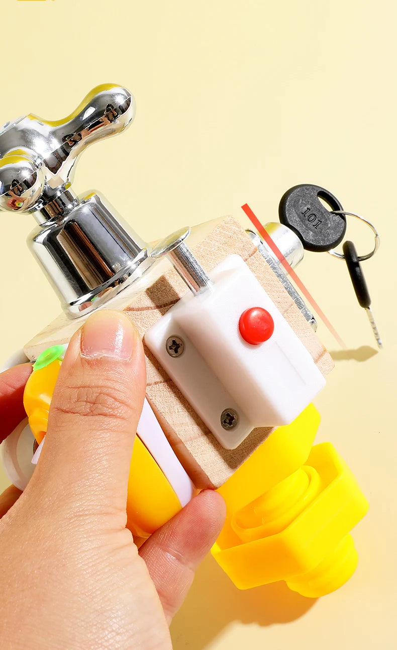 A hand holds a wooden sensory learning toy featuring a metal faucet and various components for toddlers.