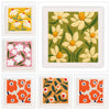 A collection of four square embroidery samples featuring floral patterns in various colors and textures.