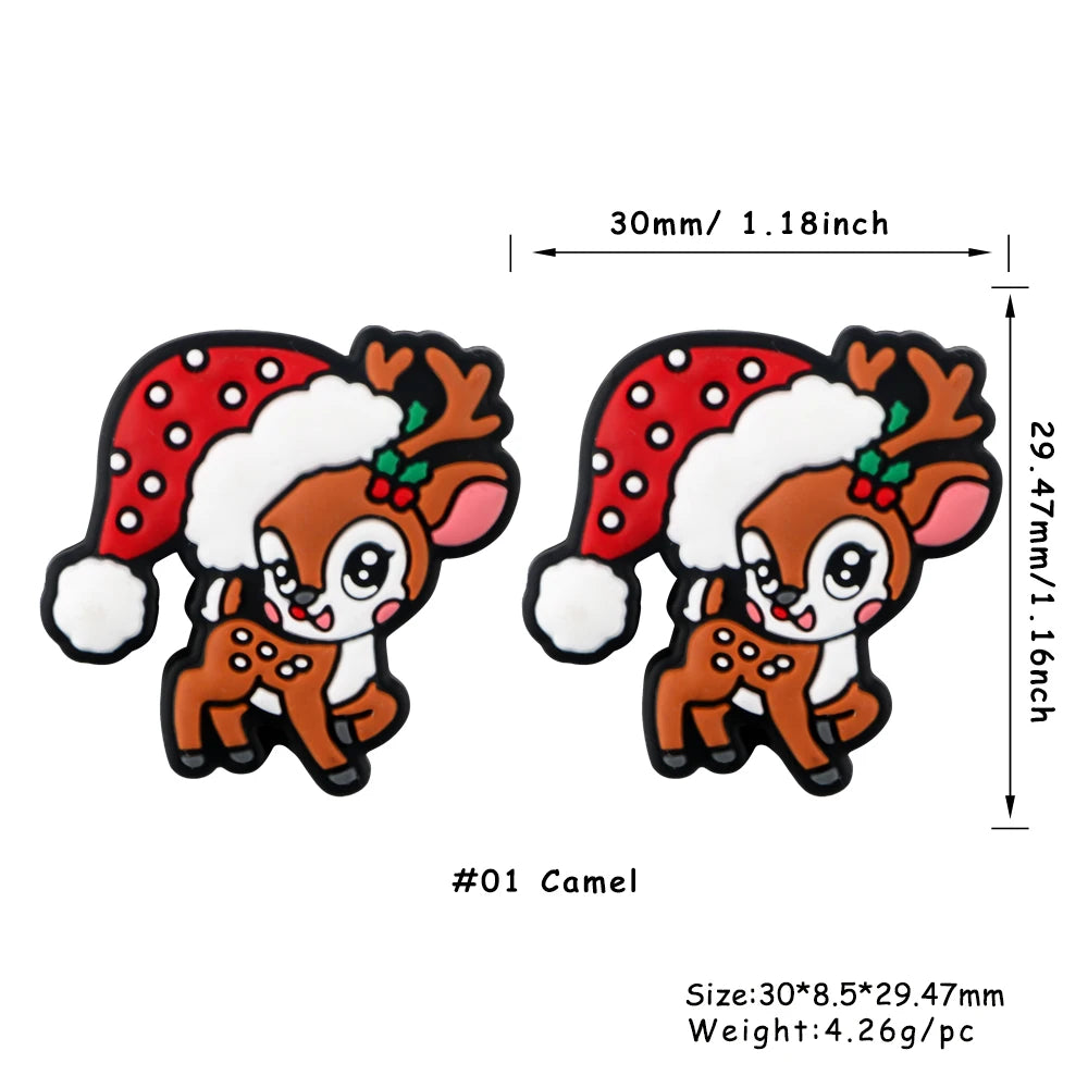 A pair of brown silicone beads shaped like reindeer heads with red and white festive Christmas patterns.