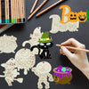 Hand painting wooden Halloween hanging ornaments on a dark surface.