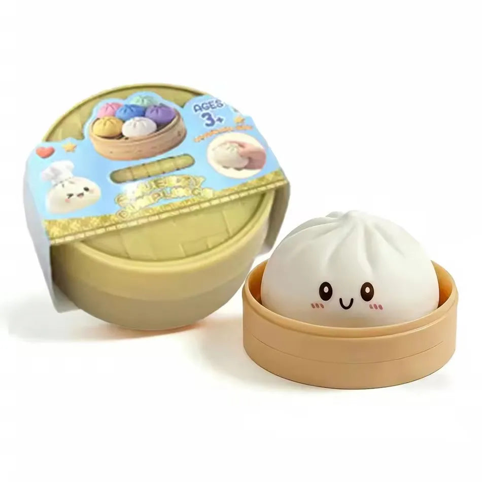 A light green and beige soft squeeze stress ball shaped like a dumpling toy with a decorative lid.