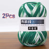 A ball of green and white soft chunky t-shirt yarn for crochet and knitting, packaged as a 2-pack.