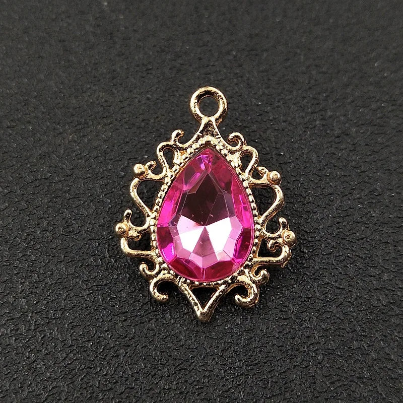 Gold plated water droplet charm featuring a pink crystal rhinestone flower.
