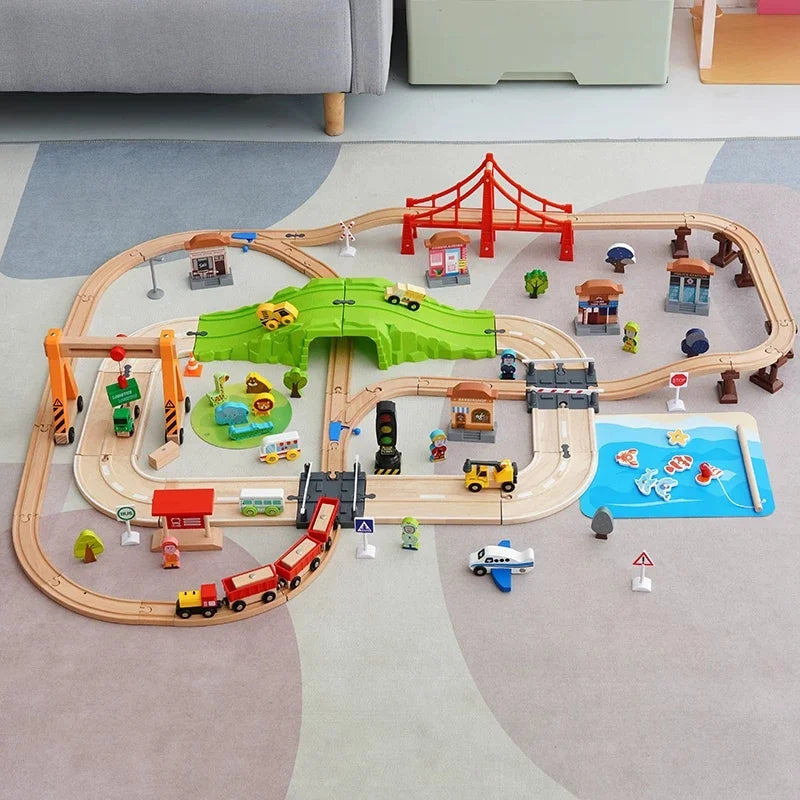 Holzspielzeug-Zugstrecke für Kinder mit Zügen, Brücken und Landschaft auf hellem grauem Boden.