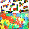 A large assortment of colorful plastic building blocks in various shapes and colors like red, yellow, green, blue, and orange