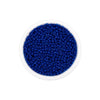 A clear container filled with small, round, deep blue glass seed beads for jewelry making.