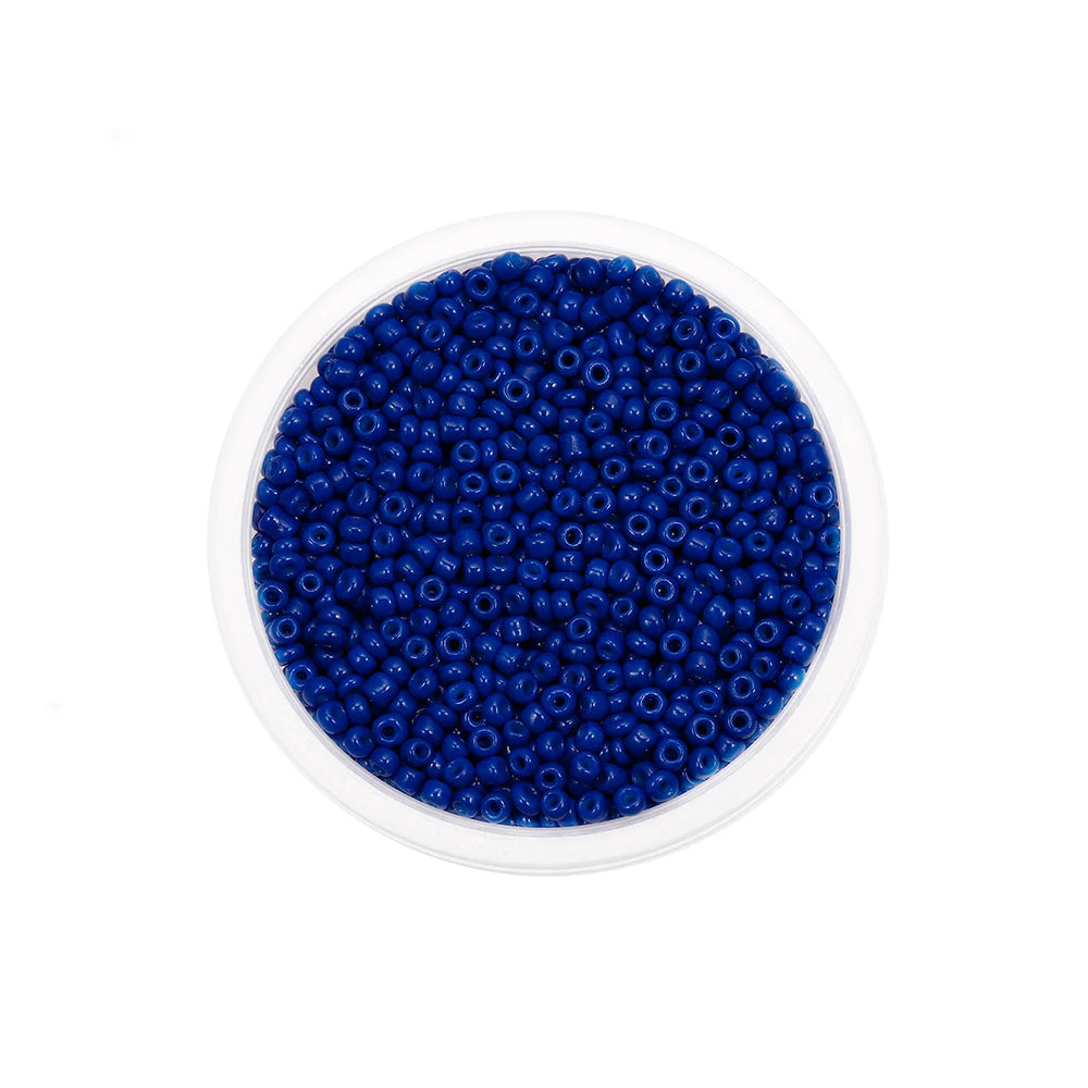 A clear container filled with small, round, deep blue glass seed beads for jewelry making.
